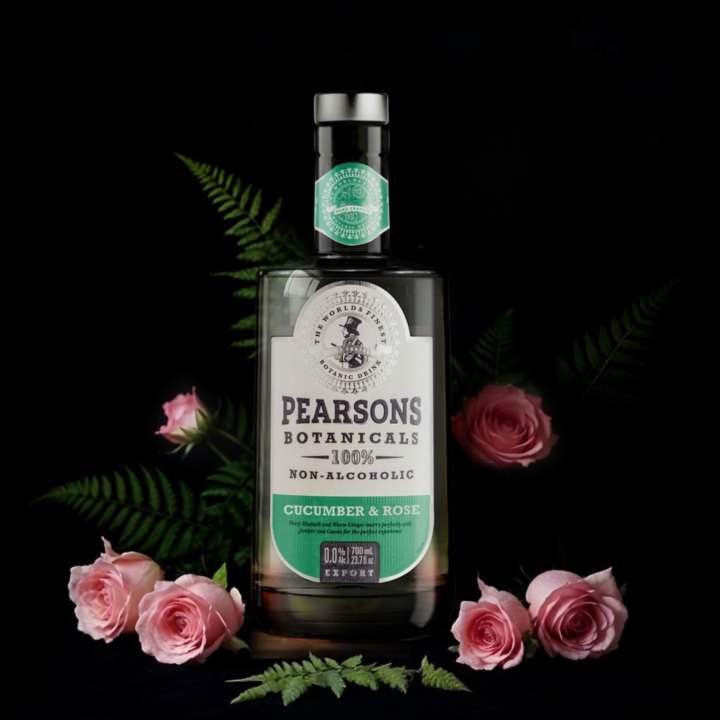 Pearsons Botanicals cucumber & rose non-alcoholic drink bottle with pink roses on a dark background