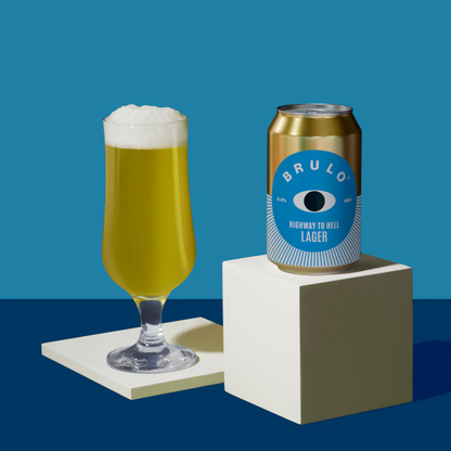Brulo beer can and glass with foam on a blue background