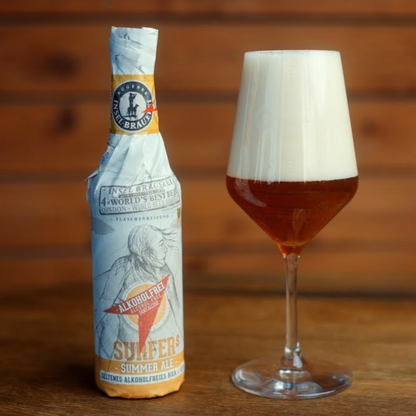 Alcohol-free beer bottle and glass with a wooden background