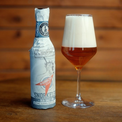 Bottle of Snorkel beer with a glass of beer on a wooden surface