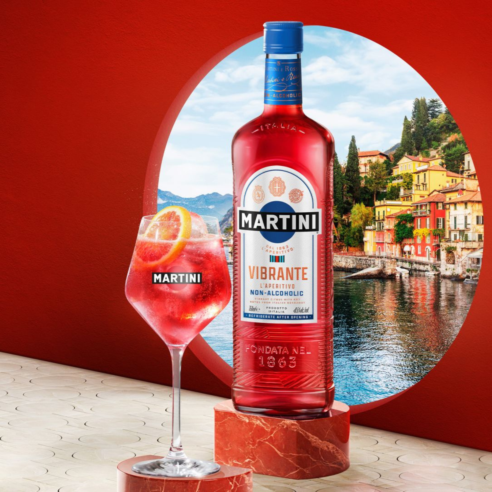 Martini Vibrante non-alcoholic cocktail bottle with a glass of the drink against a scenic background