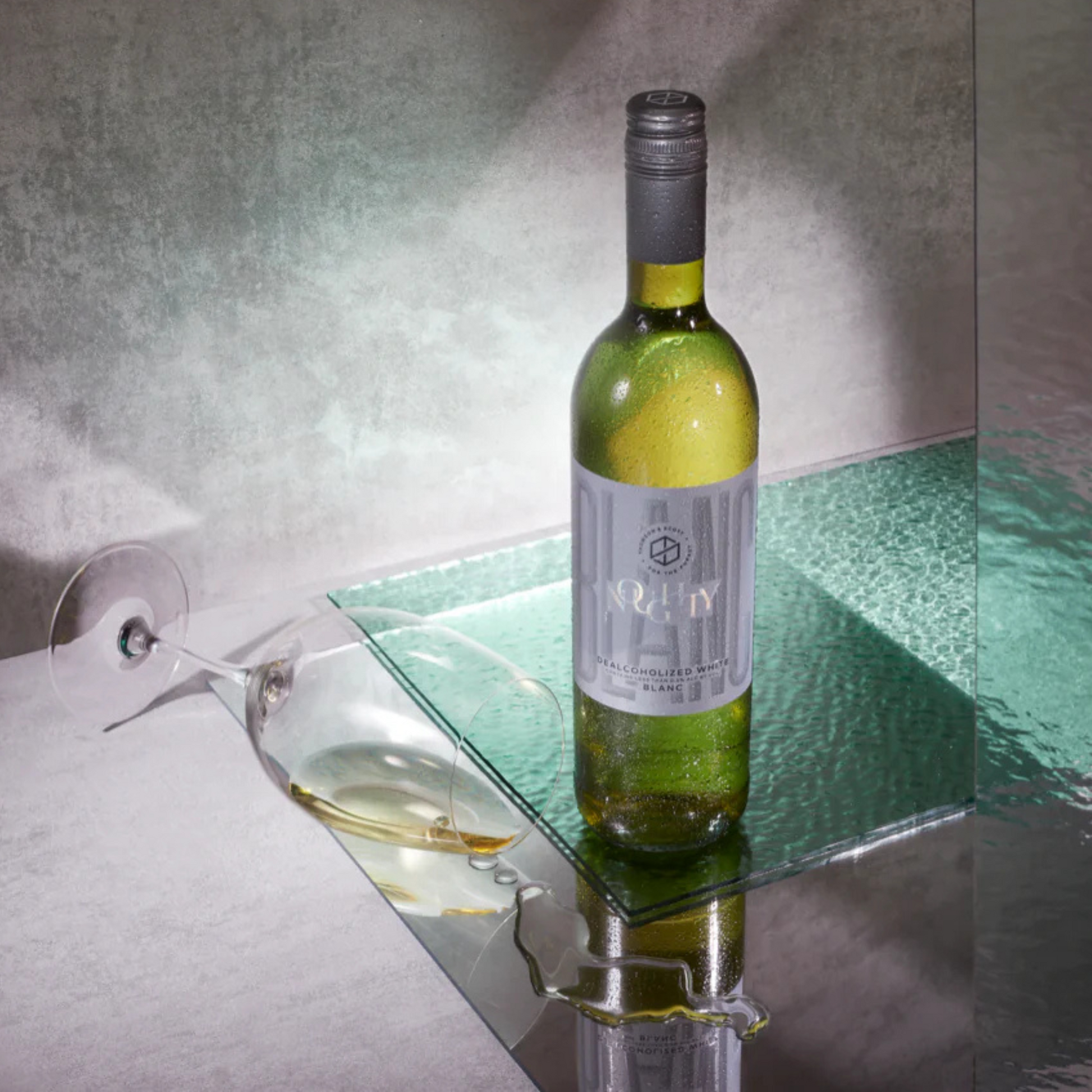 Wine bottle on a glass shelf with a glass of wine beside it